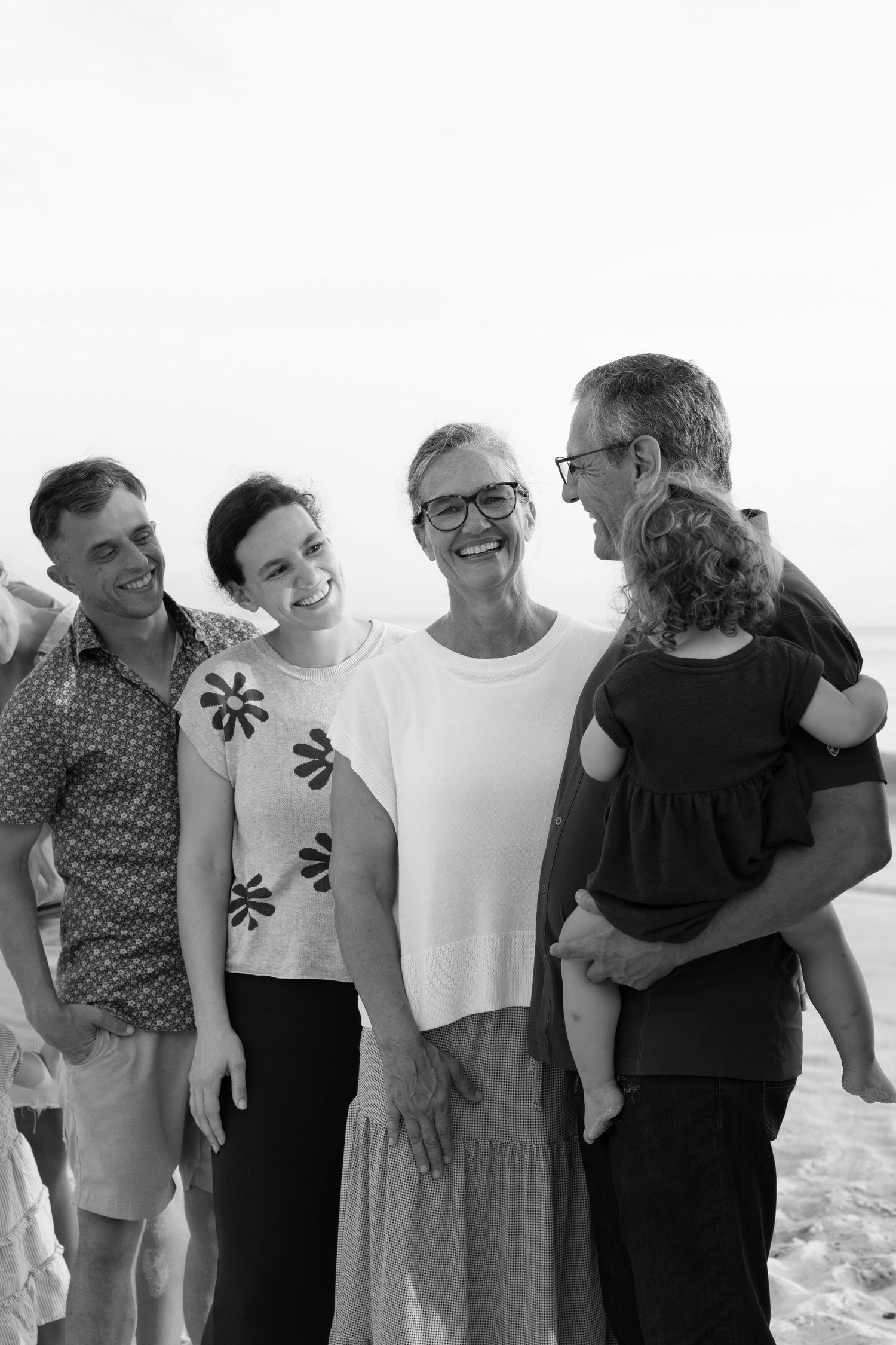Family portrait photography session at Playa Burros, Punta Mita, Mexico, capturing a family together in a timeless black-and-white portrait.