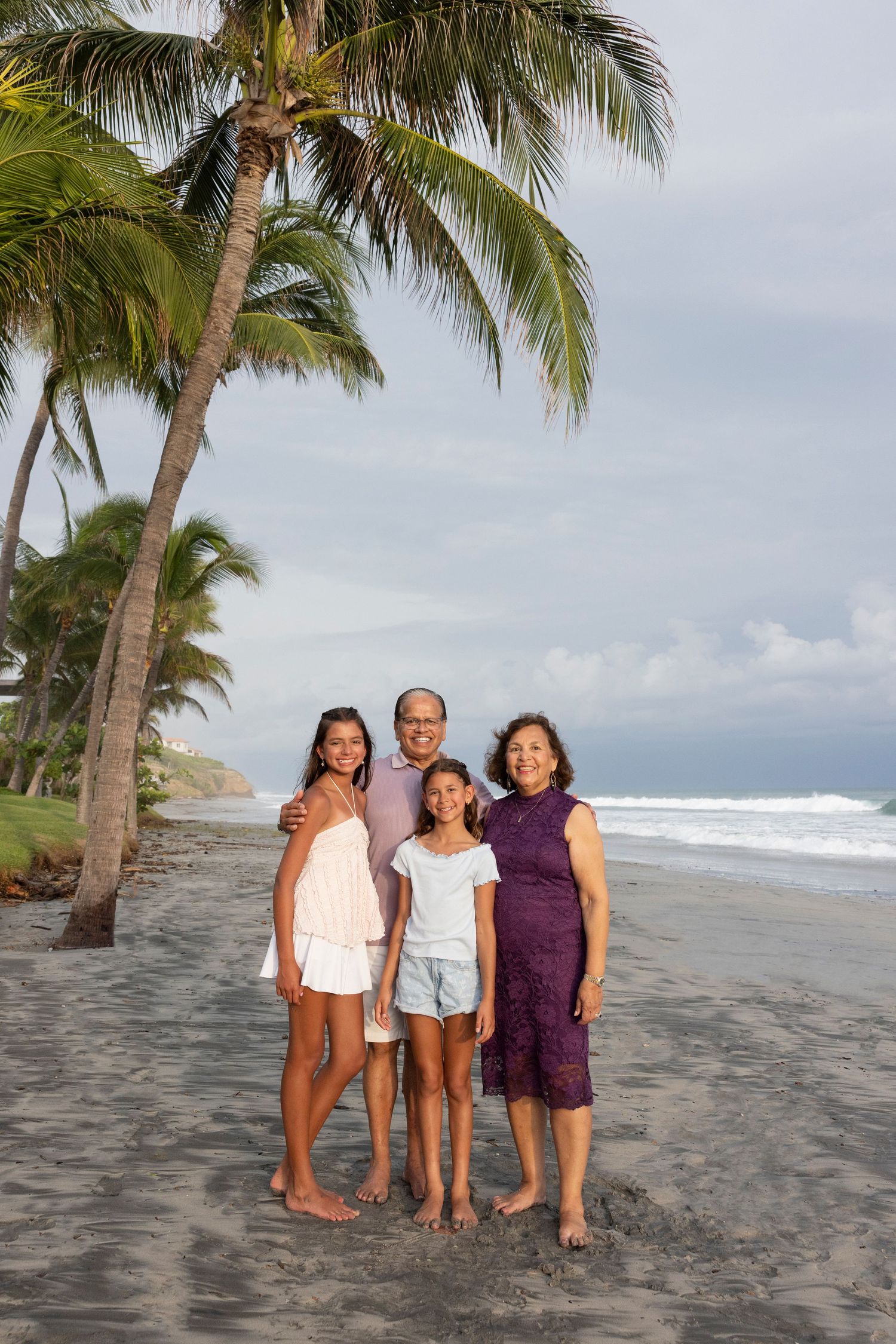 Family portrait session at Los Veneros in Punta de Mita, Mexico, capturing a mother and her daughters on a tropical beach.