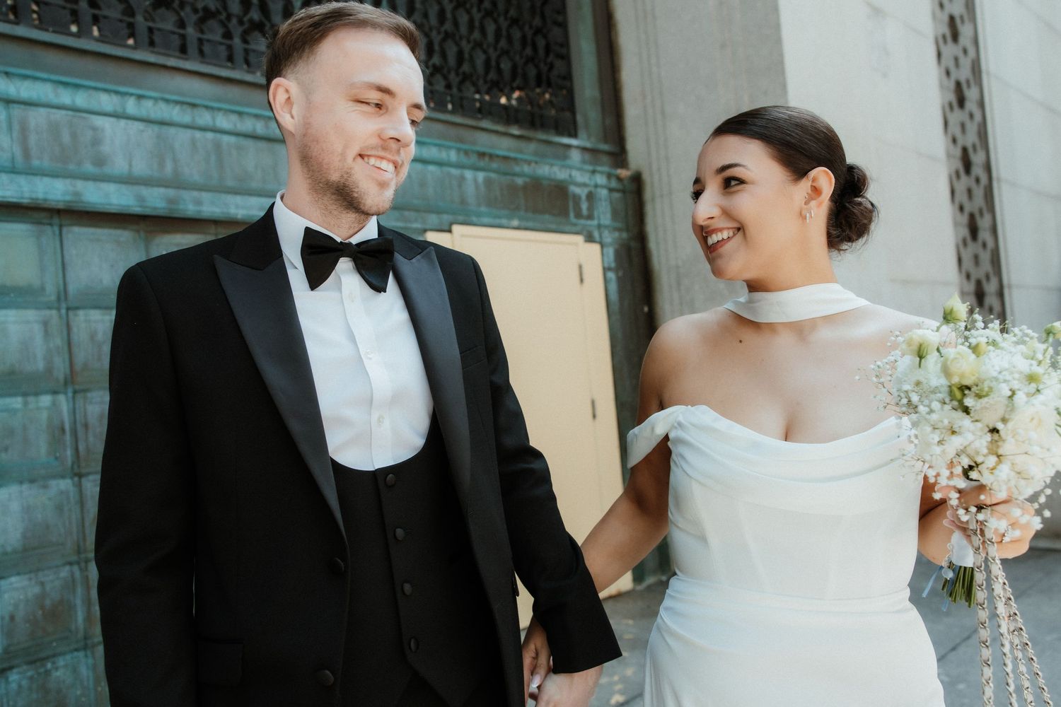 A joyful bride and groom share candid moments together during their winter wedding celebration.