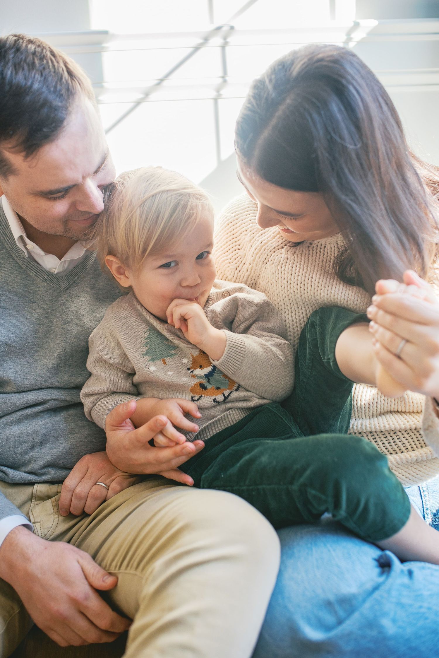 A series of tender moments showing a parent and child cuddling together on a couch.