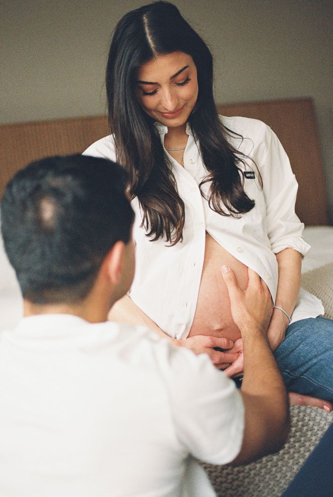 A series of intimate maternity photos showing a woman in a white shirt sitting on a couch.