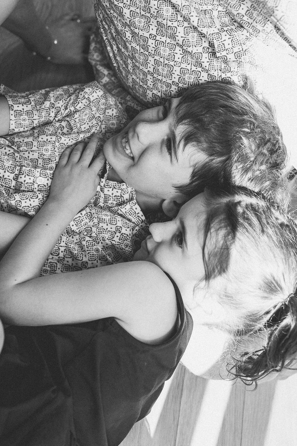 A series of black and white photos showing someone lying down with messy hair against a textured surface.