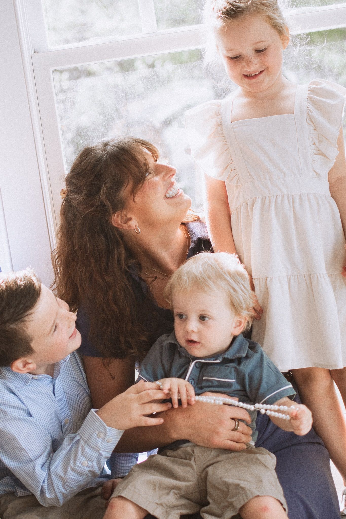 A sequence of tender family moments captured in soft natural light through window panes.