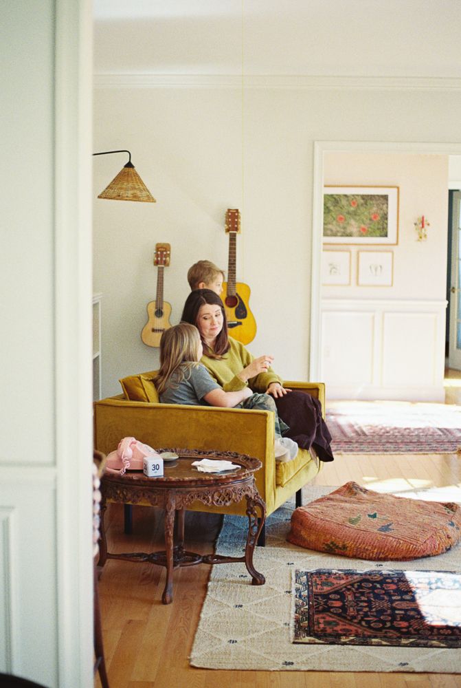 A series of photos showing a cozy bedroom interior with oriental rugs, musical instruments, and warm lighting.