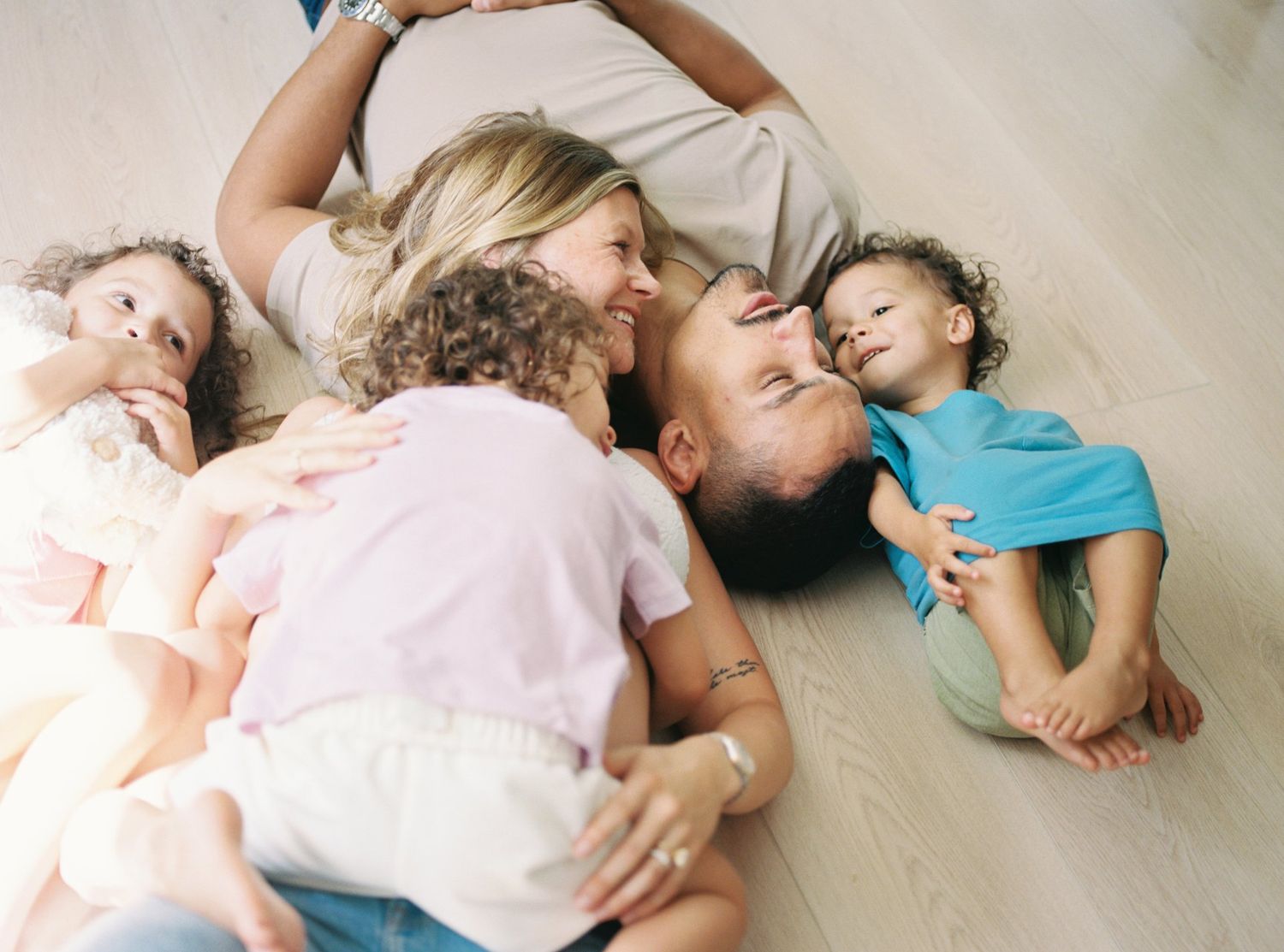 A series of five connected photos showing people lying peacefully on a light colored floor in casual clothing.