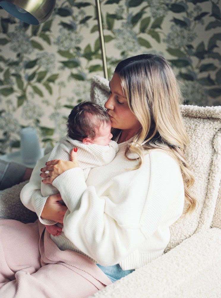 A parent shares tender moments with a baby in white clothing while sitting on a couch in a series of photos.