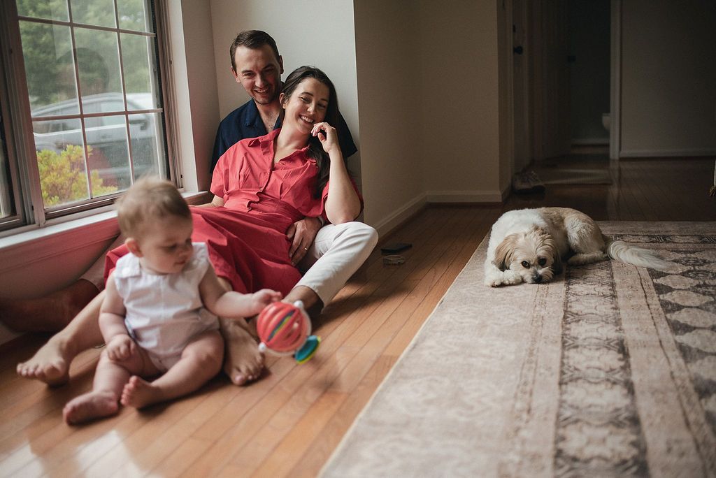 Several moments captured of an infant and adult sitting together on hardwood flooring near a window.