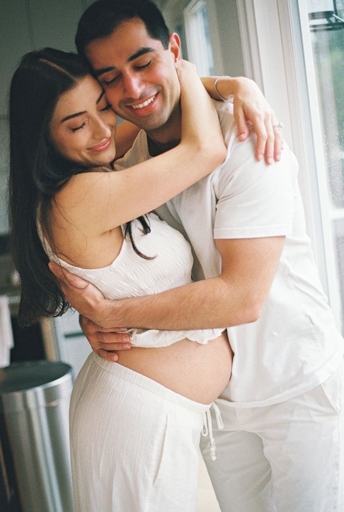 Romantic couple in white embracing by a window in a series of tender moments.