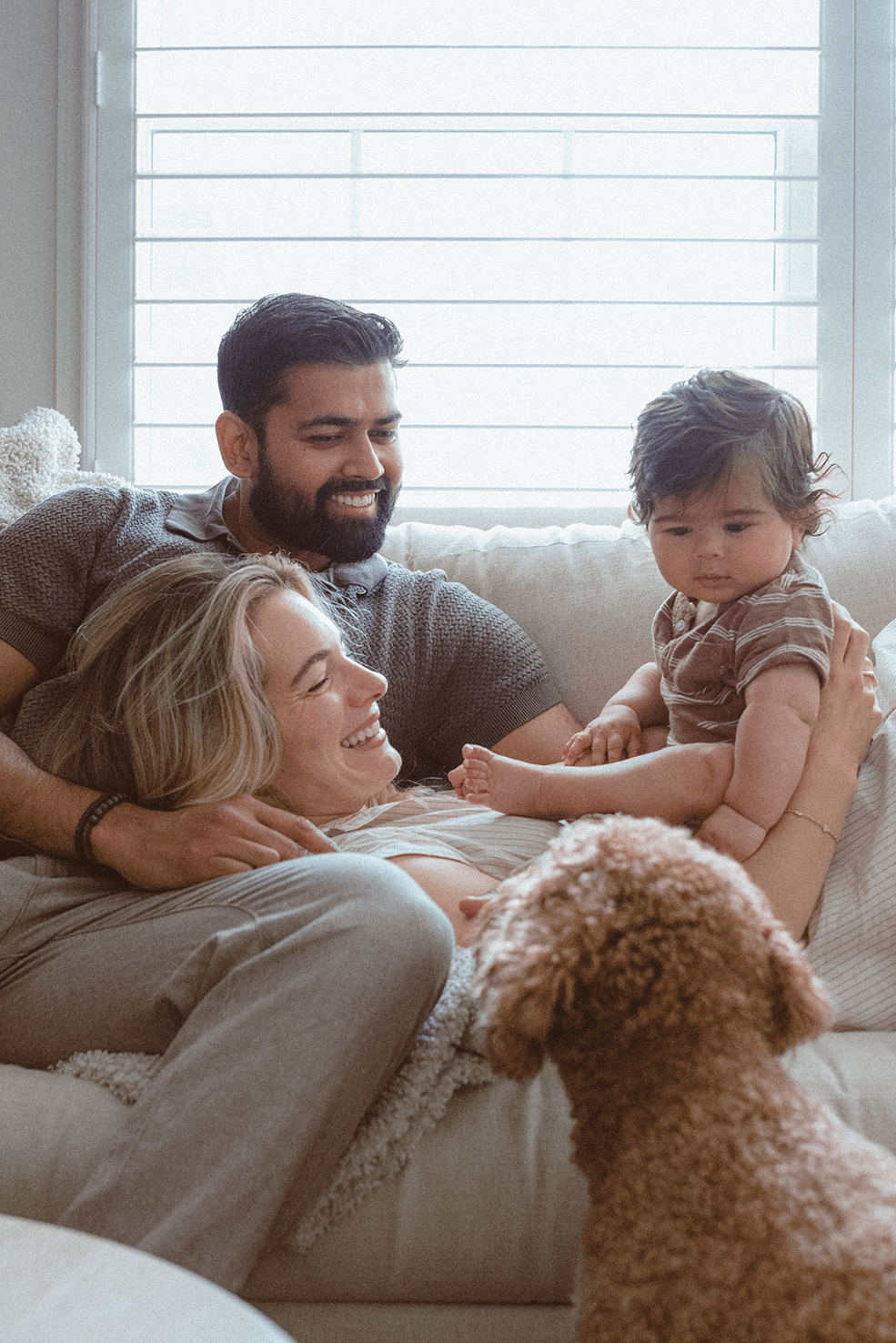 Three photos show intimate candid moments with a baby and adults relaxing together at home on a couch.