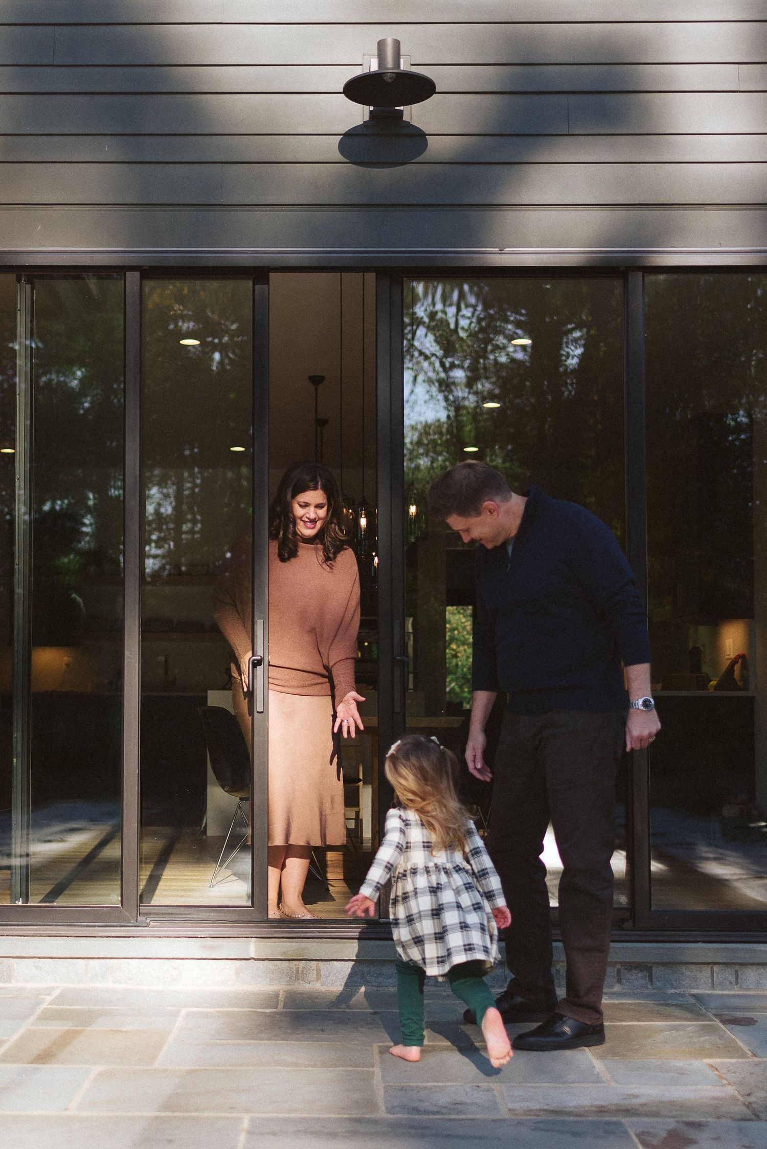 A series of photos showing people interacting near glass doors of a building entrance.