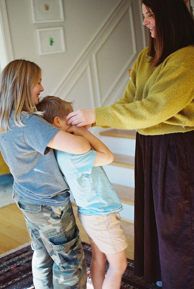 A sequence of images showing someone wearing jeans being helped up onto furniture in a room with white walls.