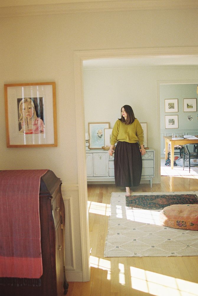 A sequence of photos showing sunlight streaming through windows onto a hardwood floor with artwork on cream-colored walls.