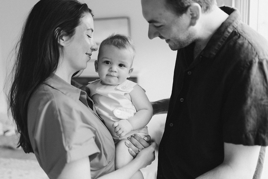 Black and white photo strip showing intimate family moments and tender interactions.