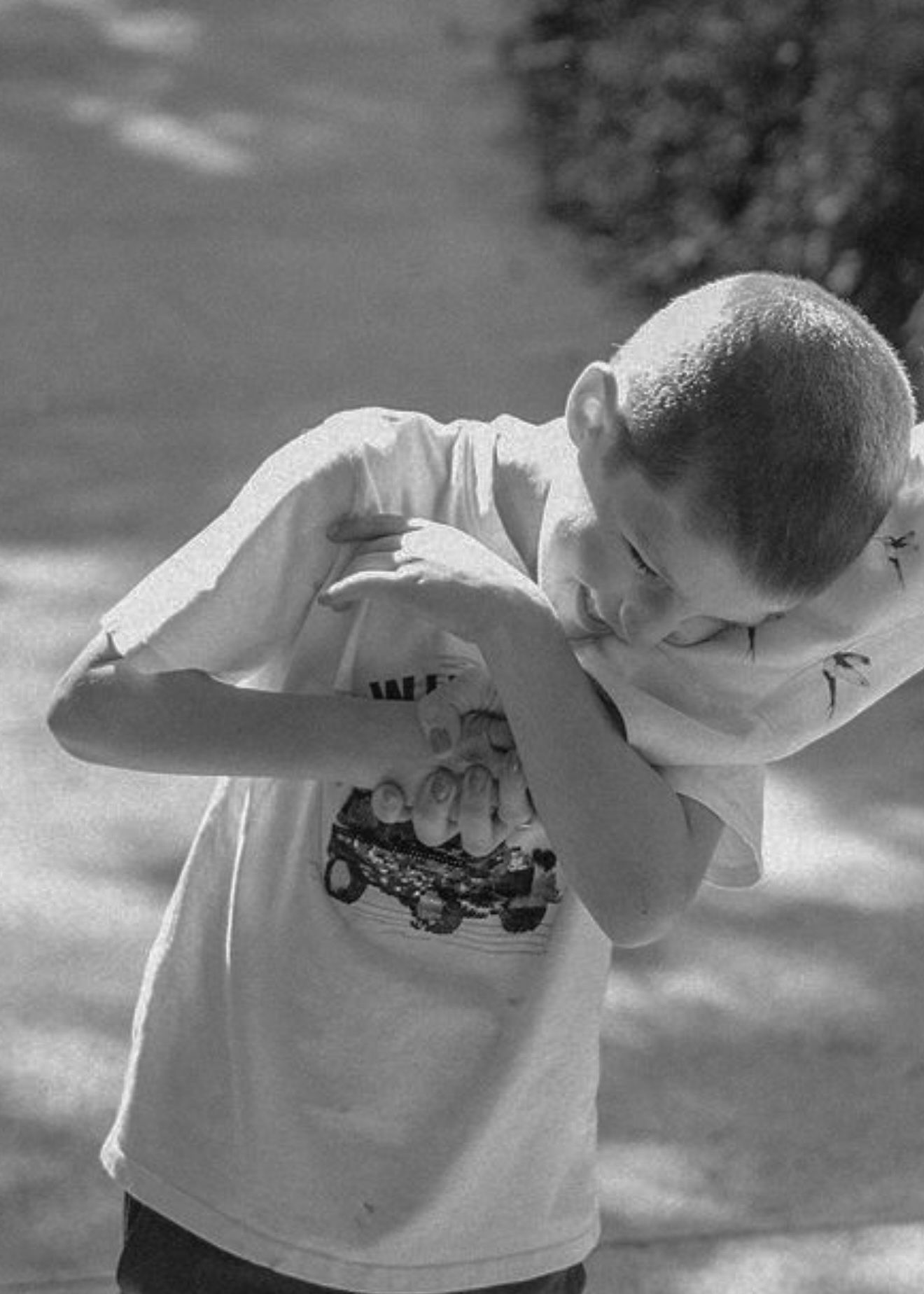 A sequence of black and white photos showing someone in a white t-shirt repeatedly bowing forward in a continuous motion.