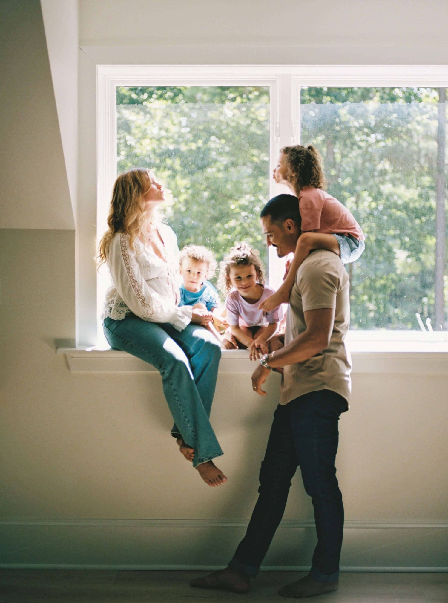 Family playing and having fun together in bright indoor space.