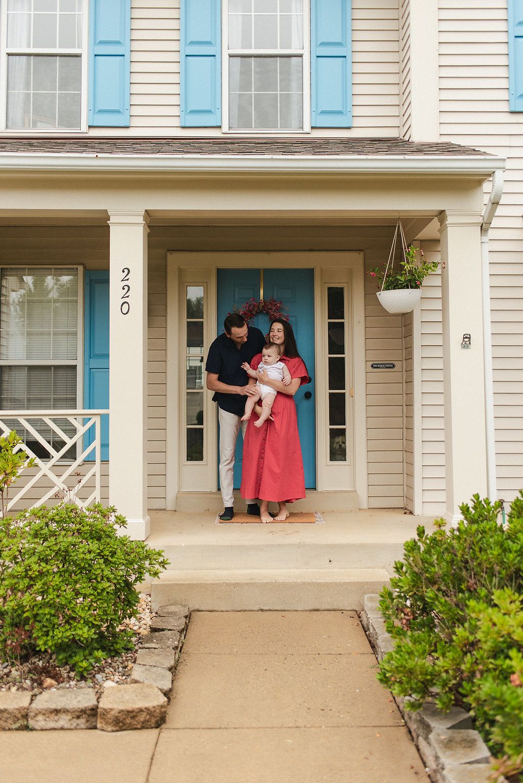 Three progressive photographs show someone unlocking a front door of a house with light siding and blue shutters.