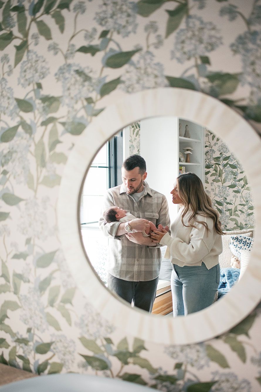 A series of oval mirror reflections showing a couple in conversation against floral wallpaper in an interior space.