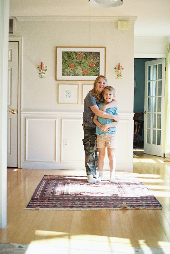 A sequence of photos showing two people dancing together in a sunlit room with a large oriental rug.