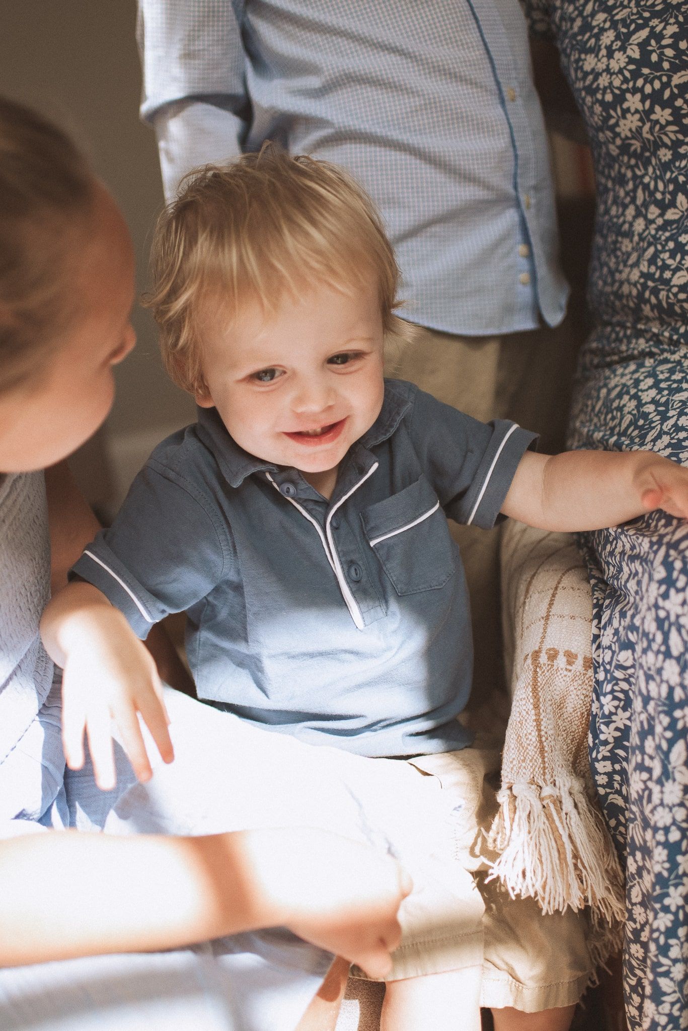 A series of candid photos showing a young child in a grey shirt sitting on a beige couch.