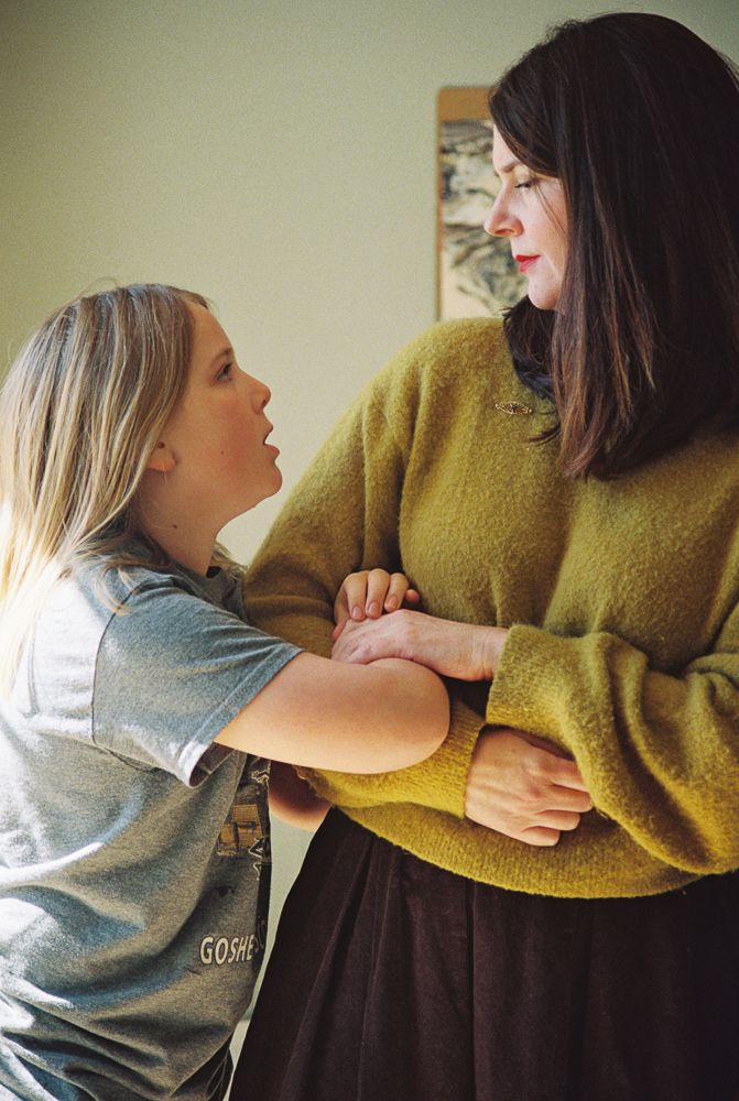 A series of photos showing playful interaction between two people wearing a yellow sweater and gray shirt.