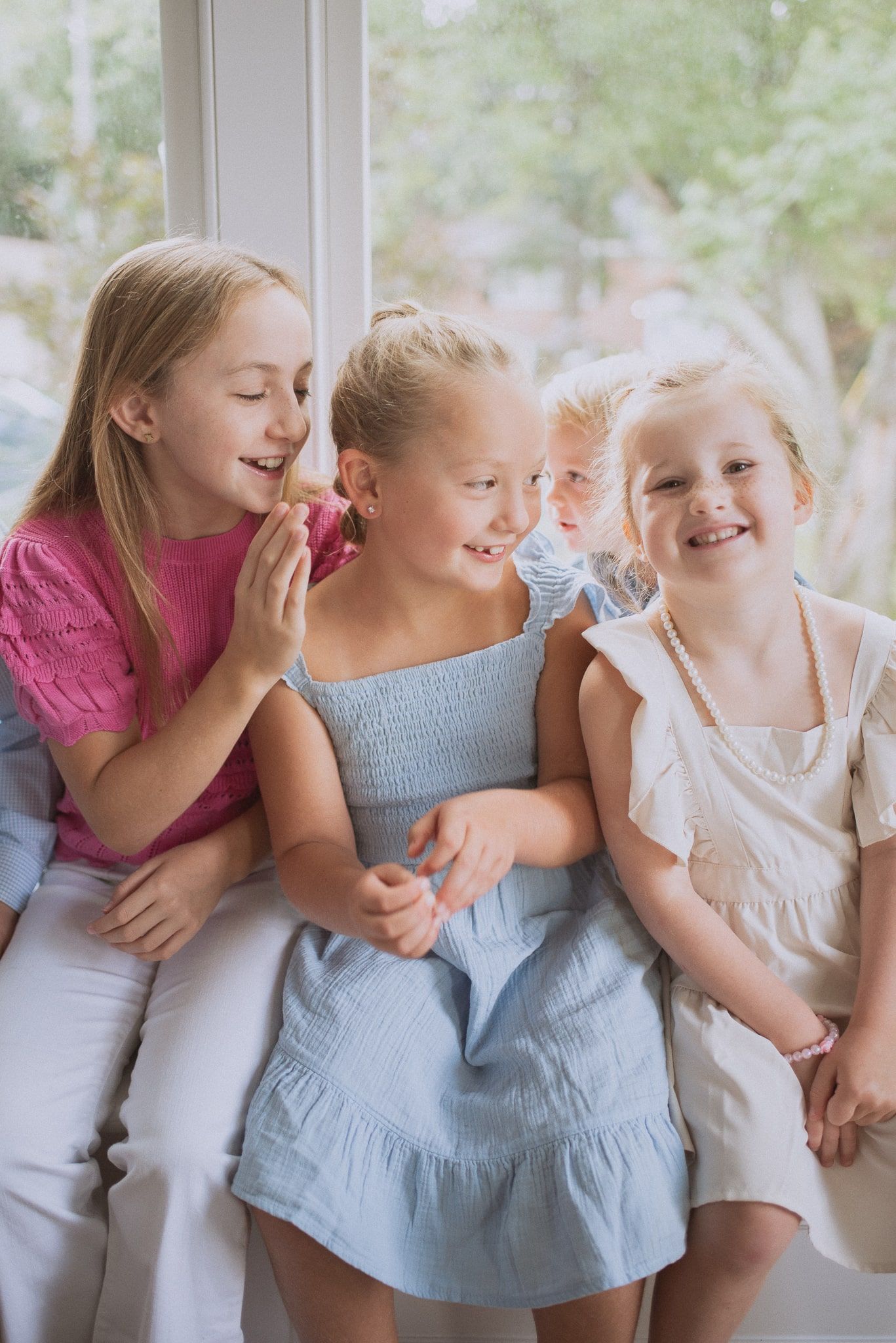 A series of candid shots showing joyful laughter and playful interactions in front of a bright window.