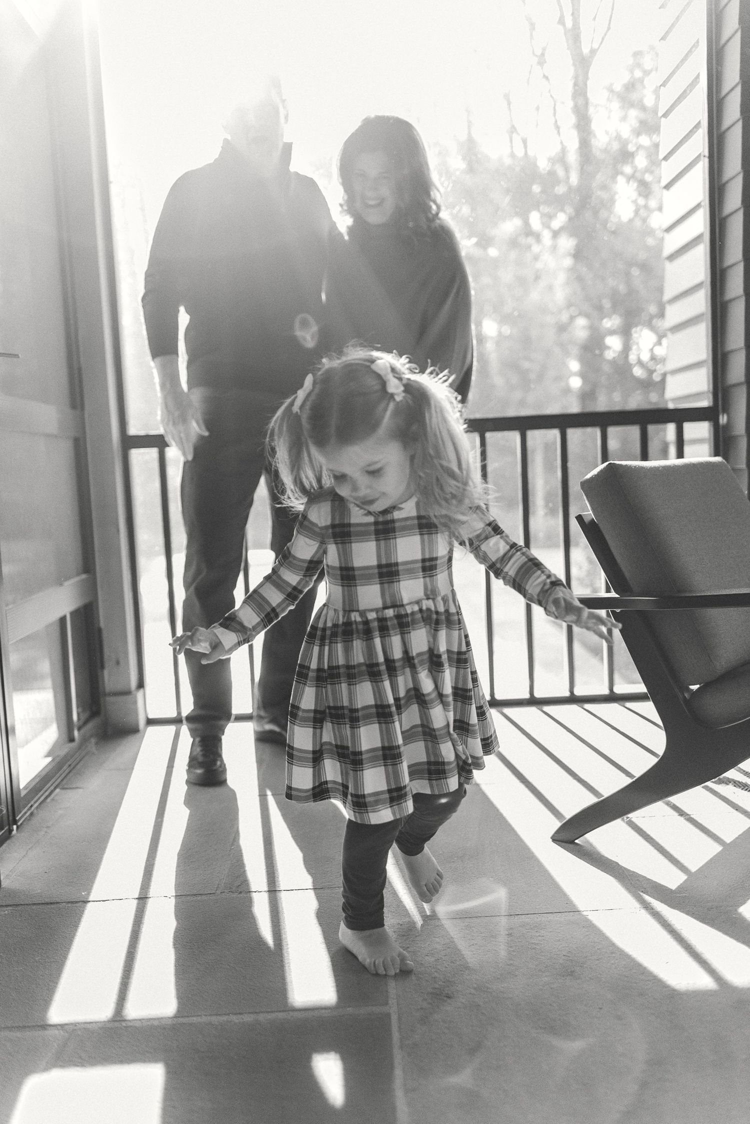 A sequence of black and white photos showing a child walking on a sunlit porch with long shadows cast.