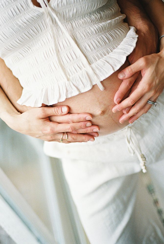Close-up sequence of hands gently clasped together showing rings against white fabric.