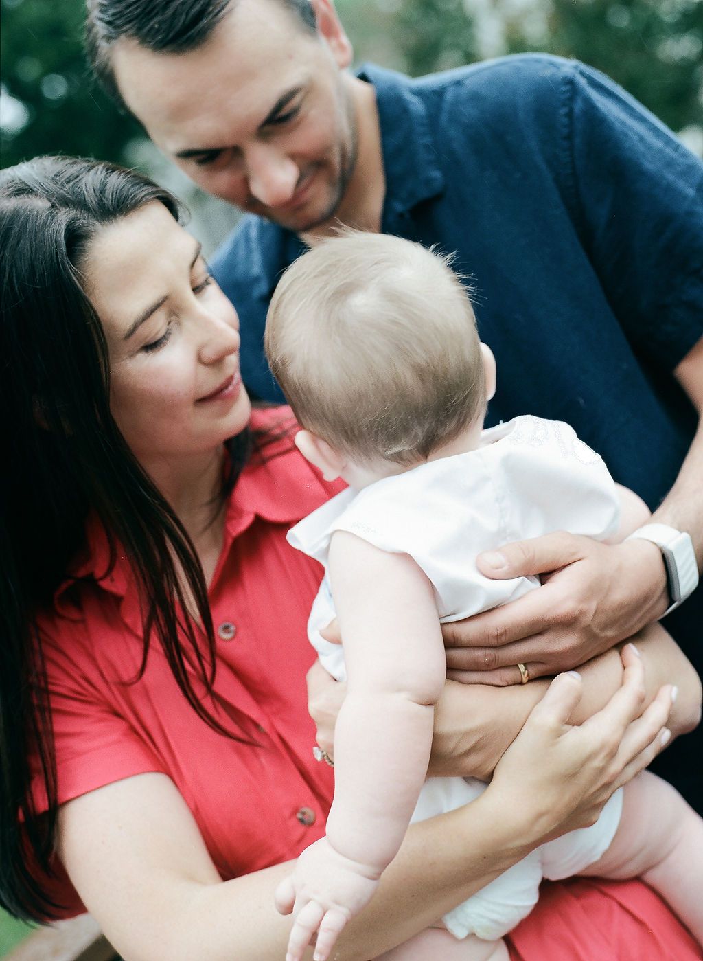 A series of intimate outdoor family portraits showing tender moments between parents and their infant in casual clothing.