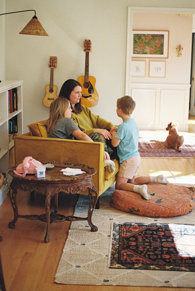 A series of photos showing a cozy living room with a carved wooden coffee table and area rugs in different angles.