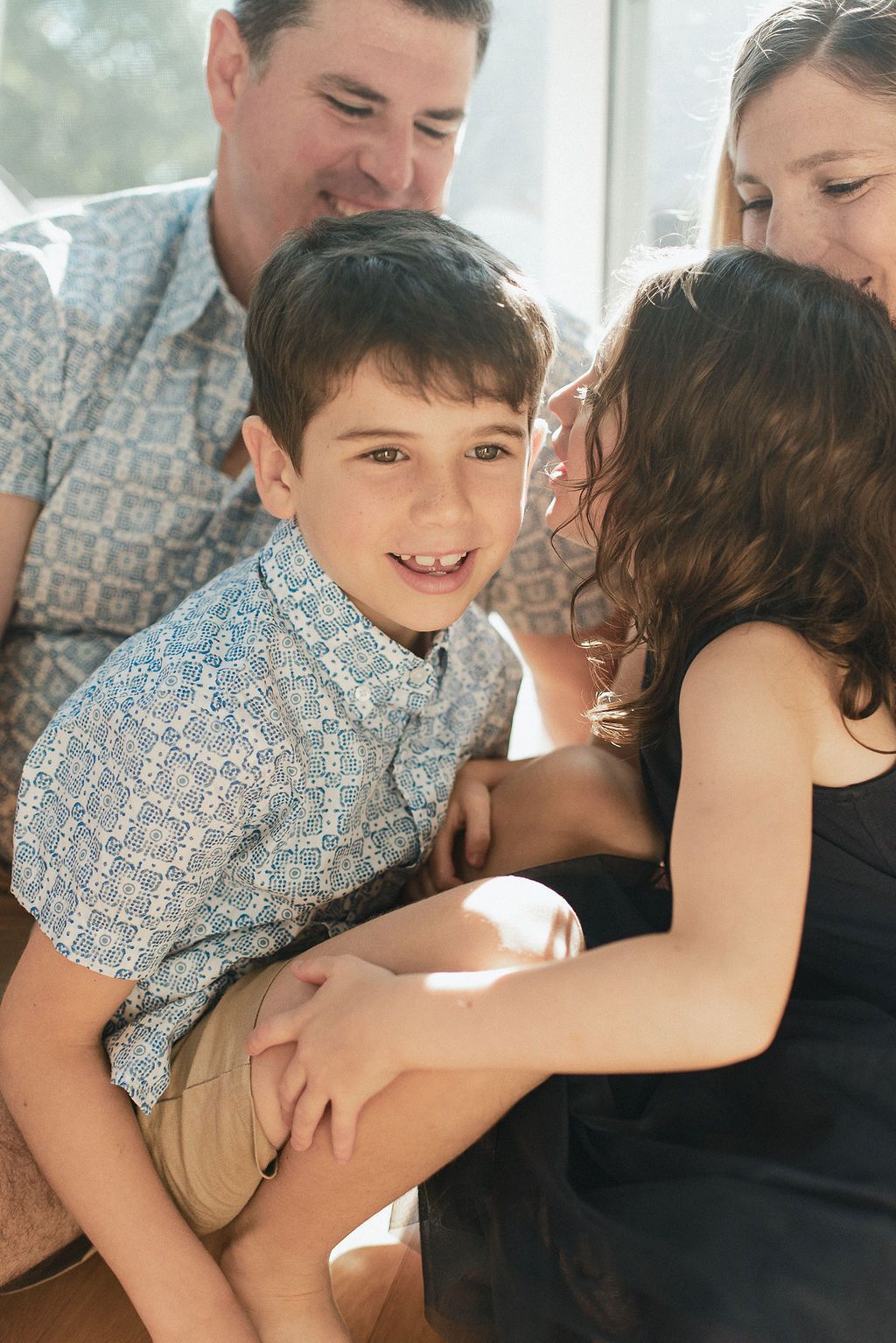 Family candid photos showing playful interactions between parent and child in casual home setting.