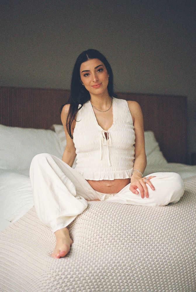 A series of connected photos showing someone in a white sleeveless top lounging on a bed with white bedding.