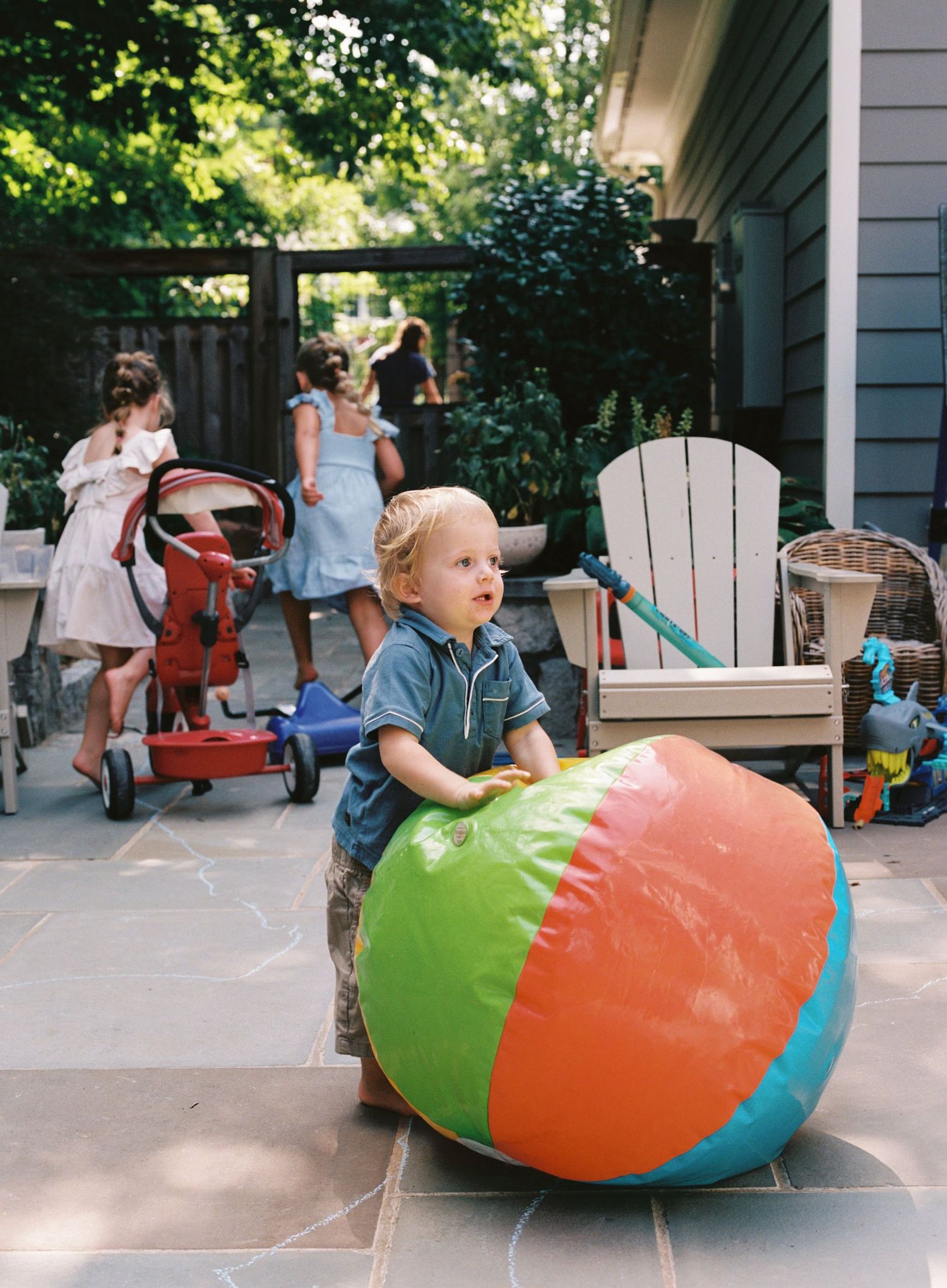 A series of photos showing a colorful inflatable beach ball on a porch with outdoor furniture.