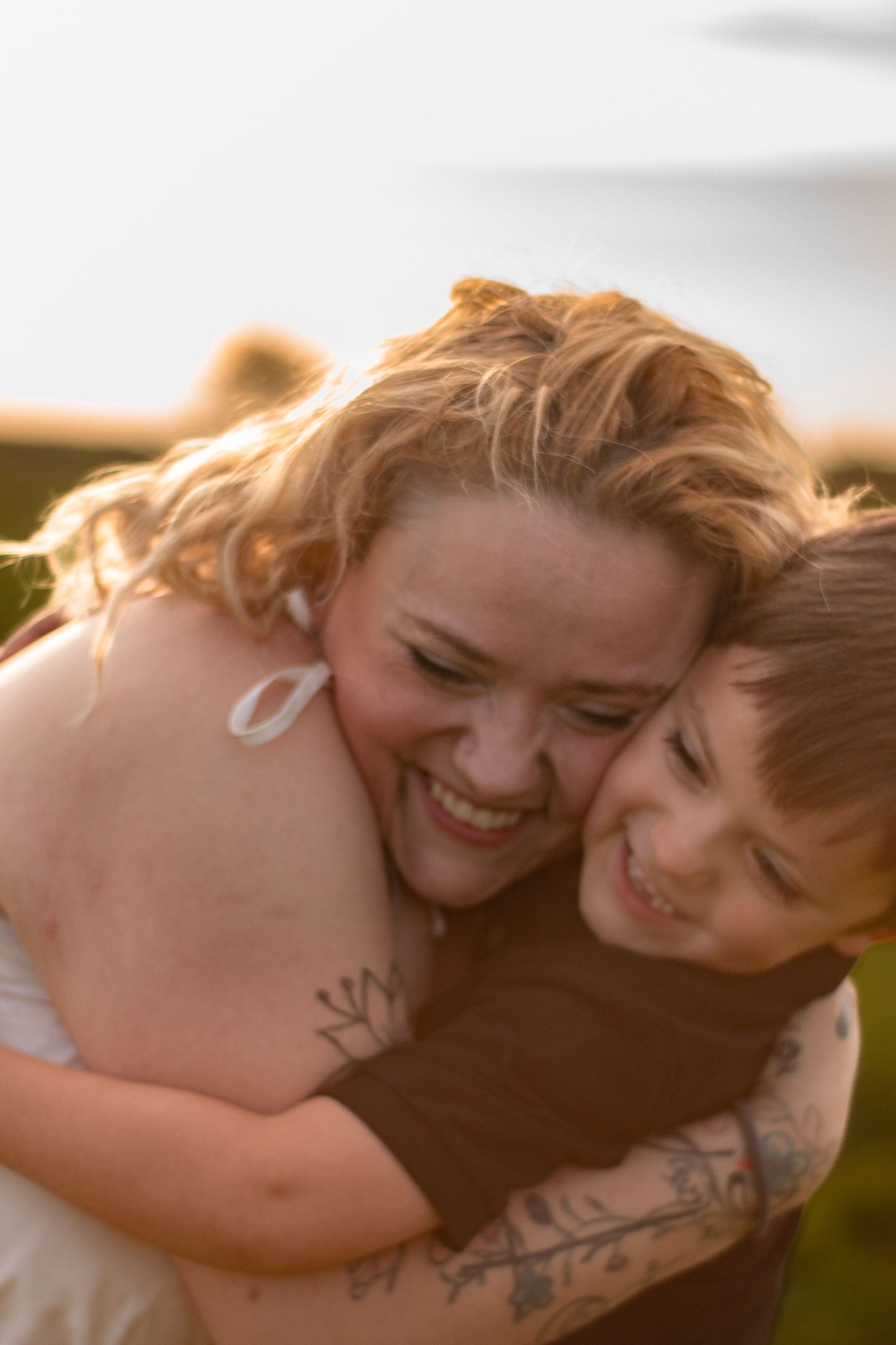 Mother hugging her son tightly during a heartfelt outdoor family photography session in Northwest Indiana