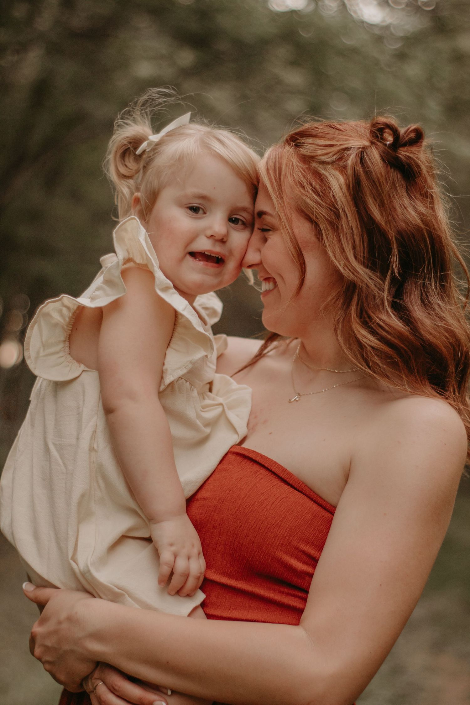 Mother and daughter snuggled together during a heartfelt outdoor family photography session in Indiana