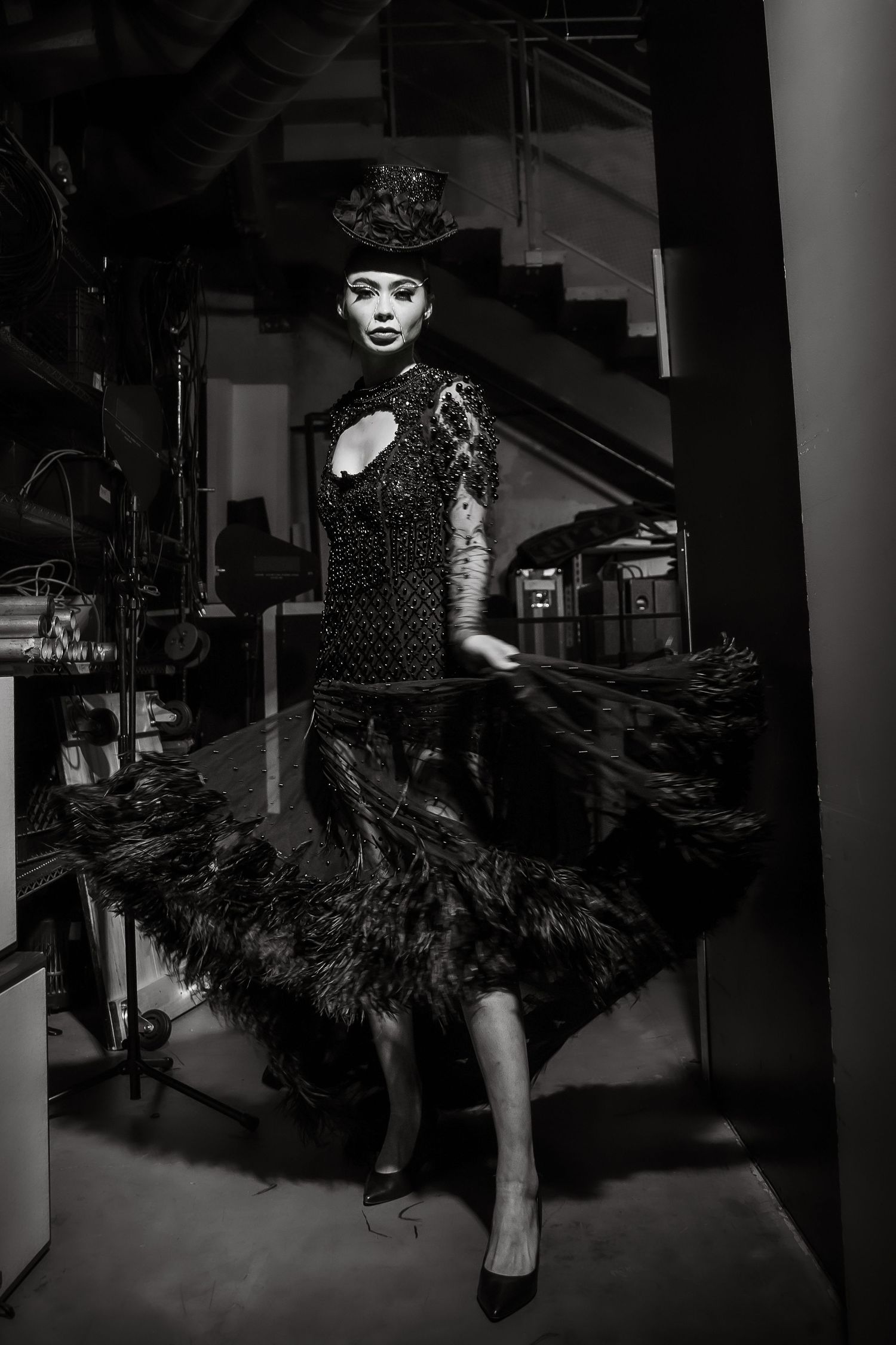 A dramatic black and white photo series shows a dancer in a flowing tutu dress performing dynamic spinning movements.