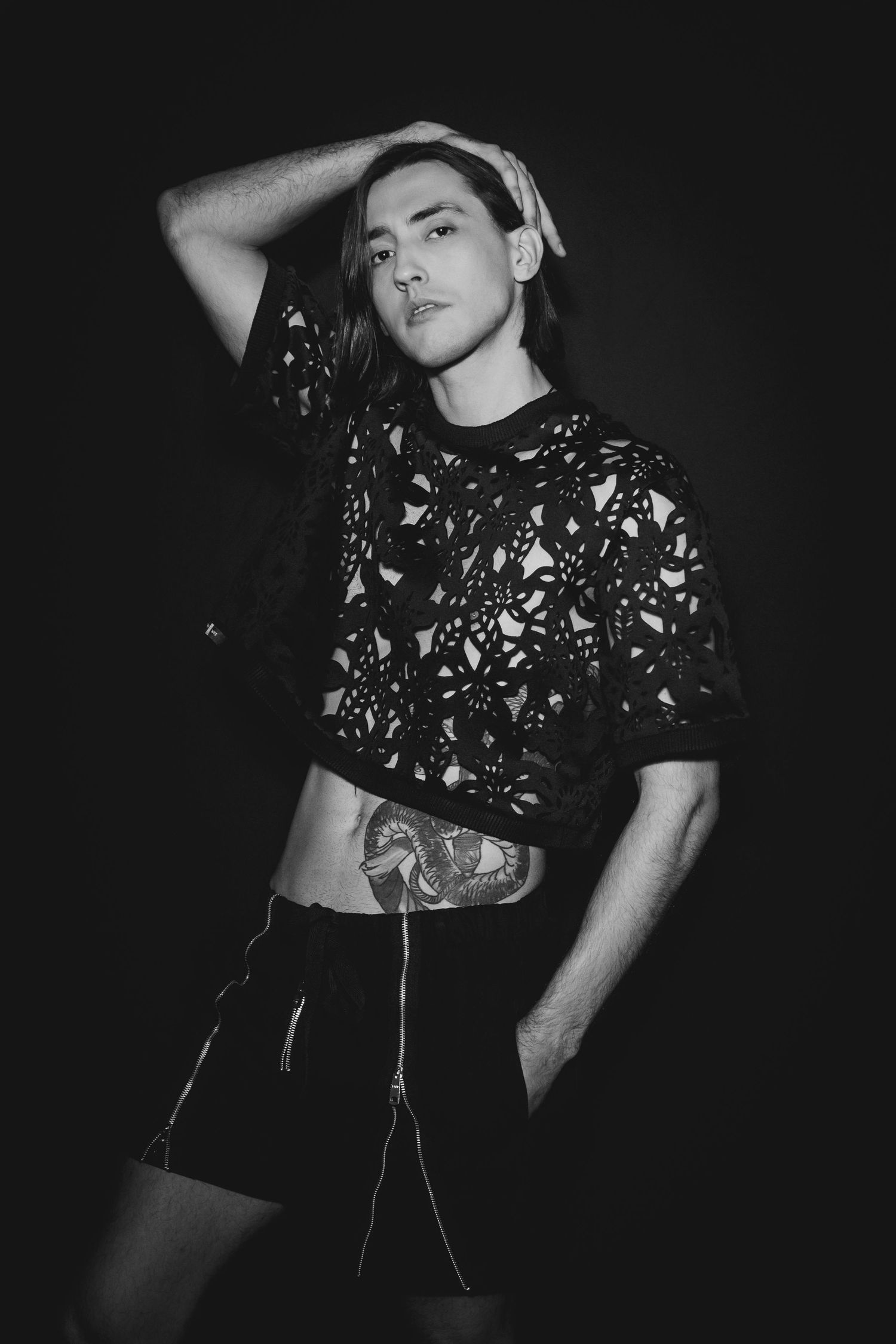 Black and white fashion photo series showing a person in a floral print crop top against a dark background.