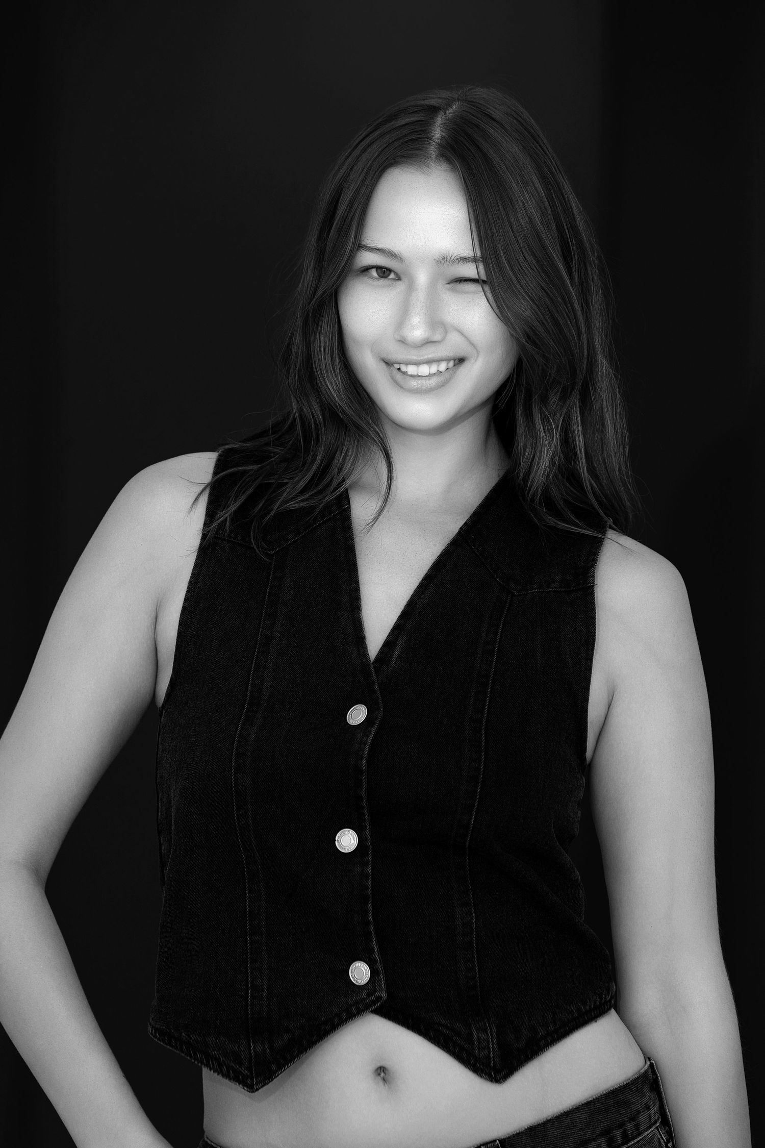 Black and white studio portraits showing a person in a dark sleeveless top against a dark background.