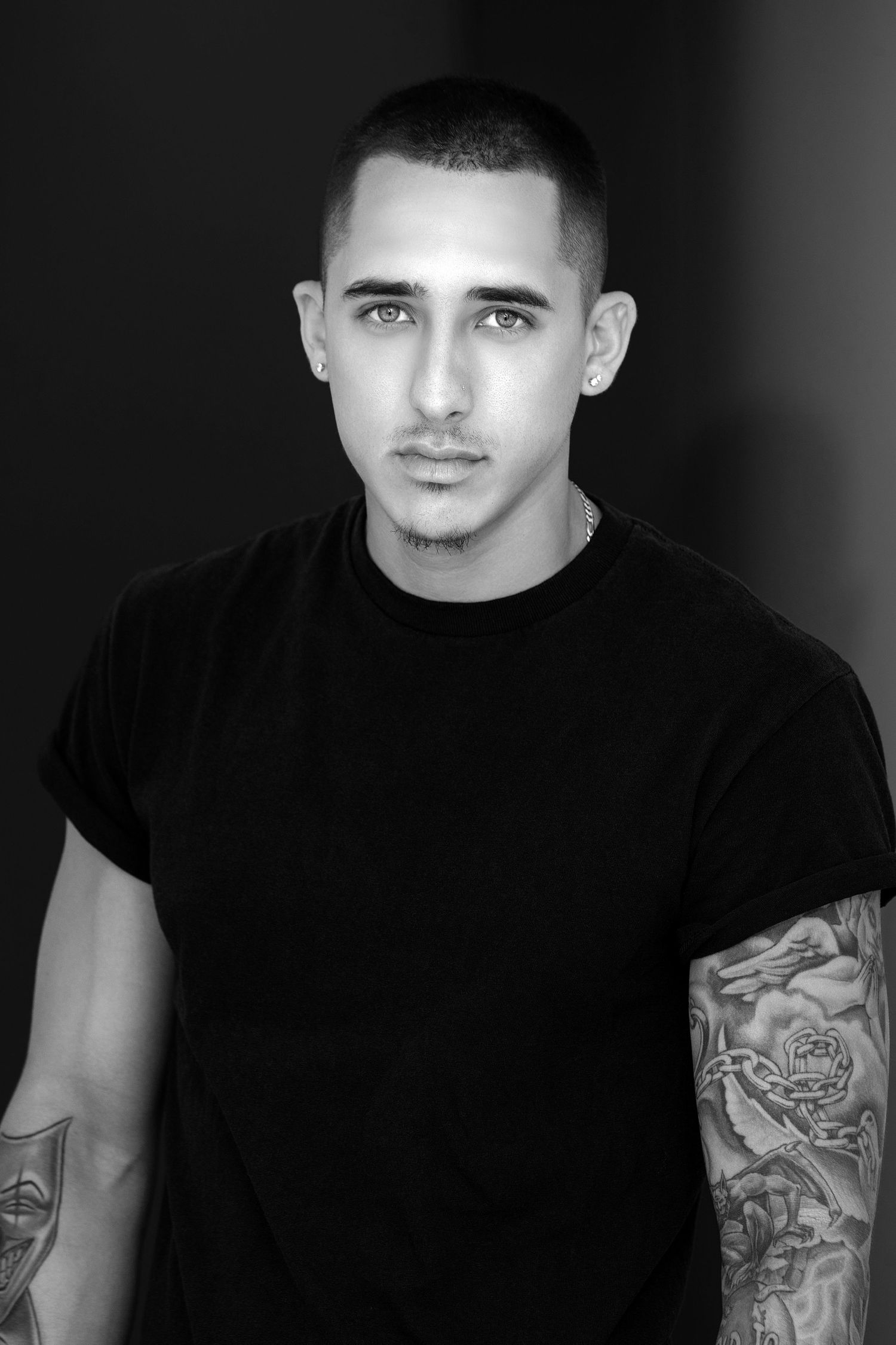 Black and white portrait series showing close-up facial expressions and tattooed arms against dark backgrounds.