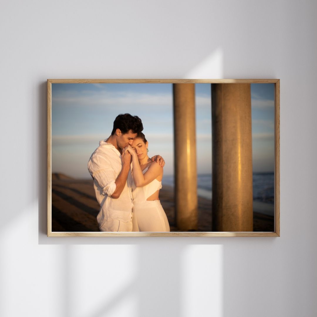 Minimalist wall display featuring framed romantic photographs in natural light.