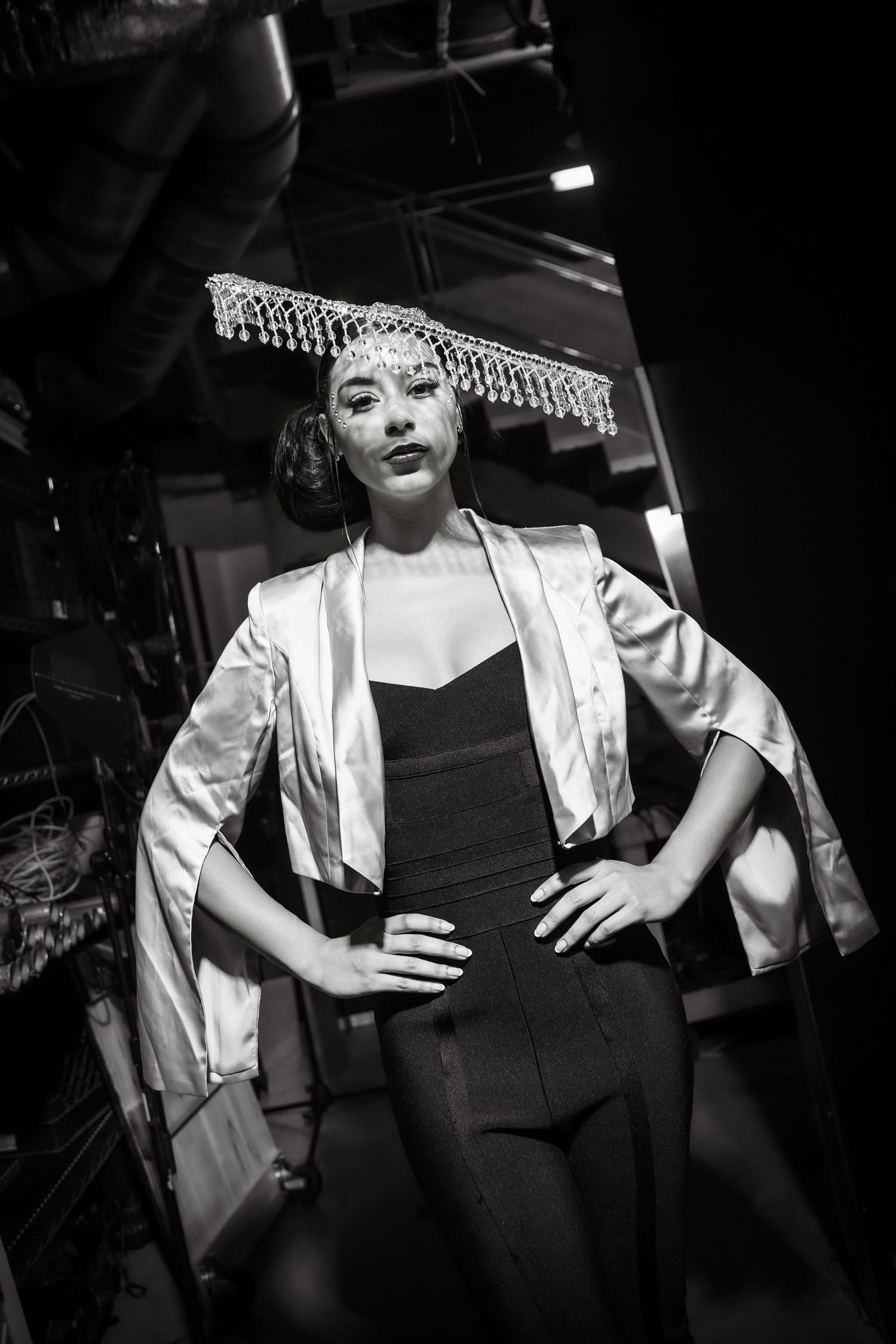 Artistic black and white photo series showing dramatic poses in white clothing against dark background.