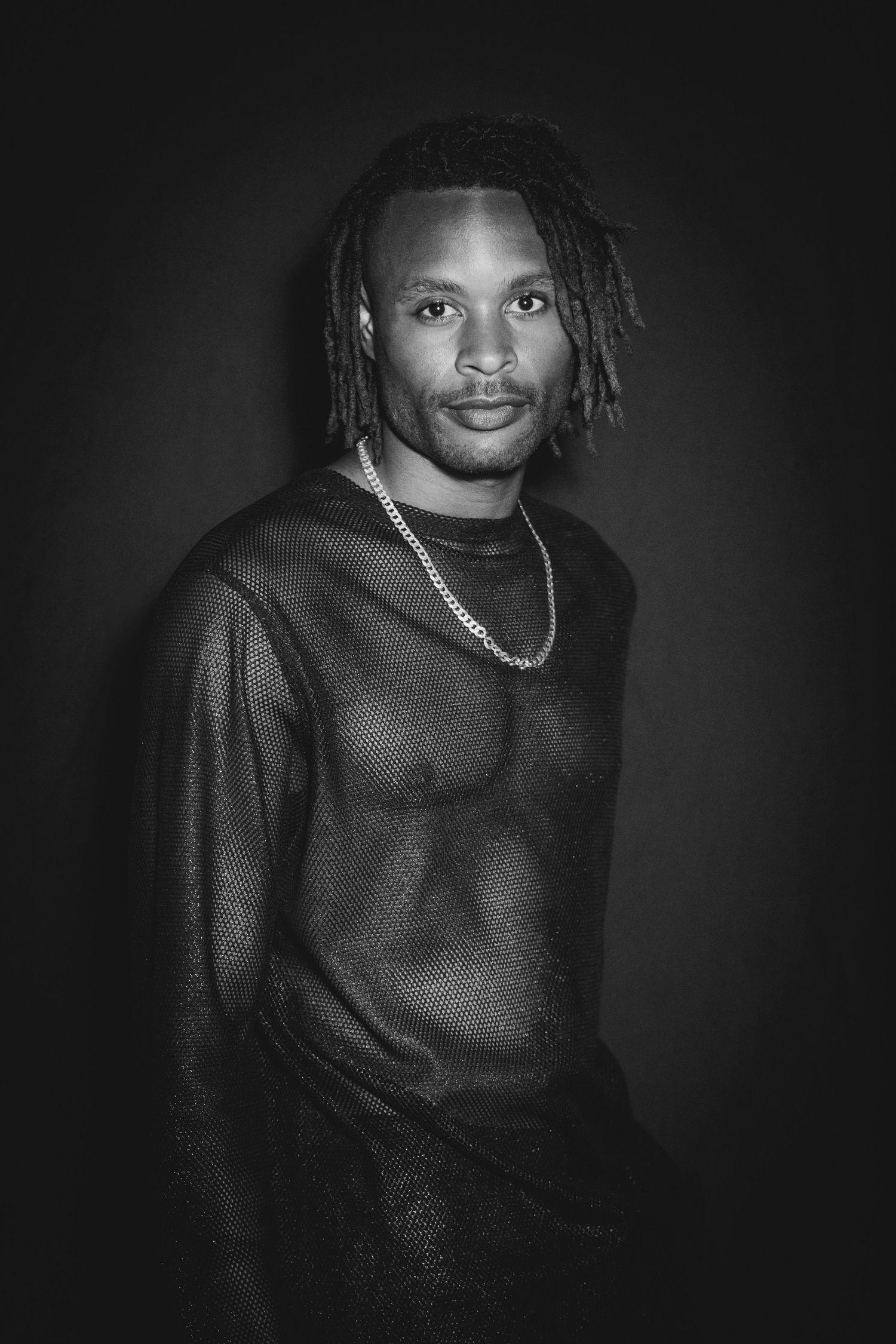 A dramatic black and white portrait series showing a person in a dark sweater with braided hair against a black background.