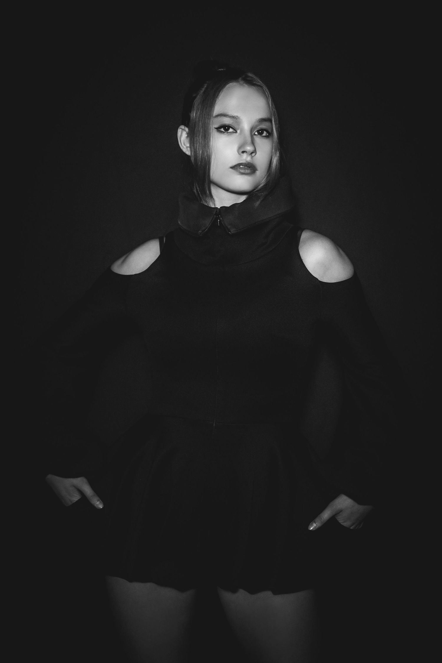 Dramatic black and white portrait series featuring dark silhouettes and moody lighting against a black background.