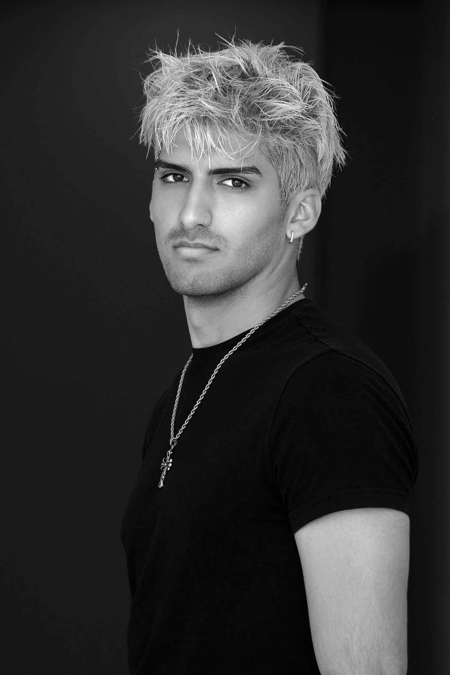 Black and white portrait series showing person with platinum blonde hair wearing black t-shirt from different angles.
