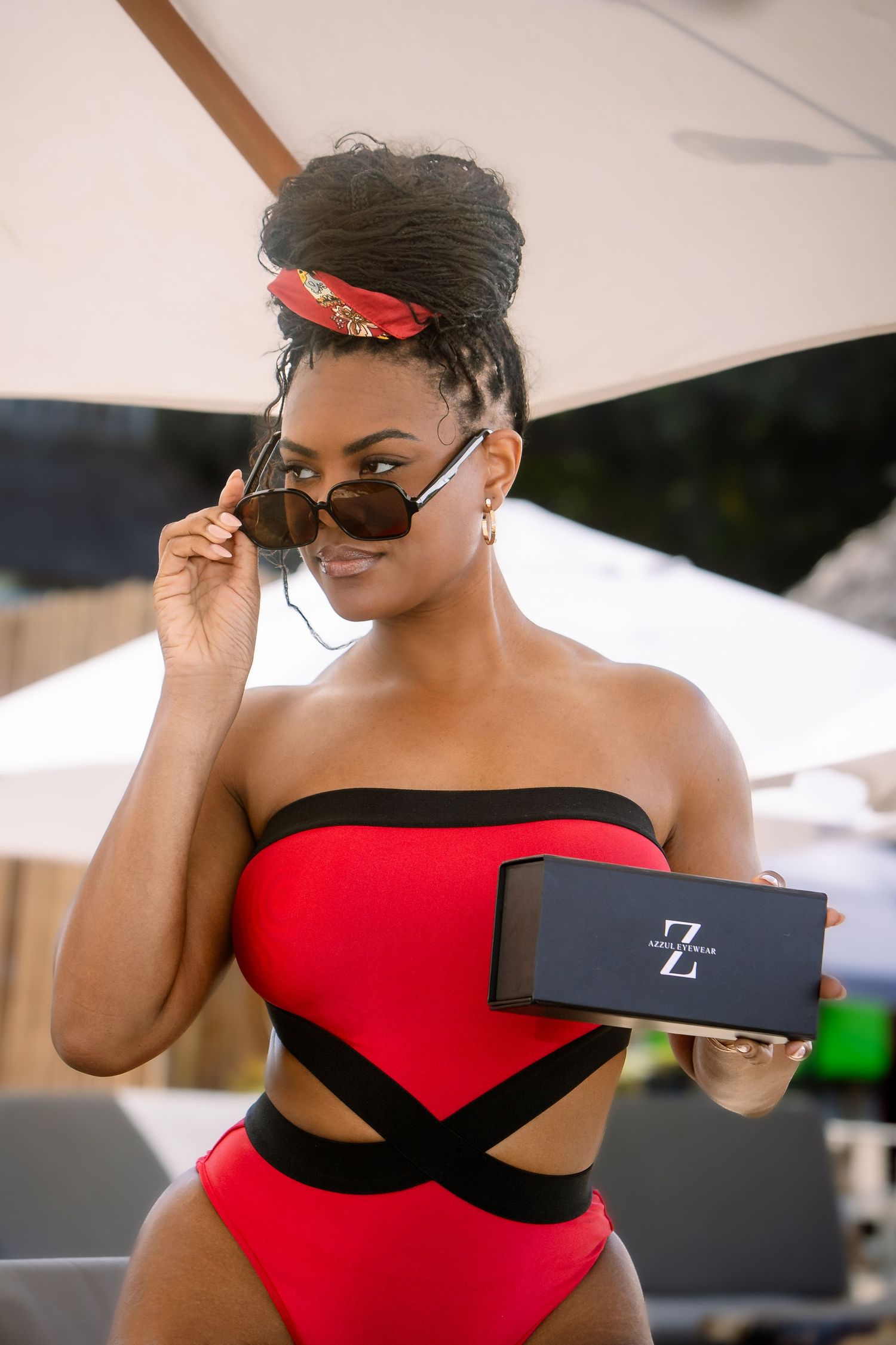 A series of fashion photos showing a red and black swimsuit from different angles in an outdoor setting.