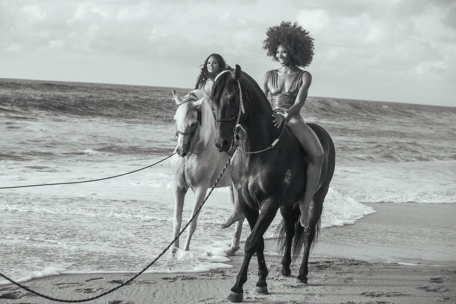 Black and white photo sequence showing people riding horses along a scenic beach shoreline.