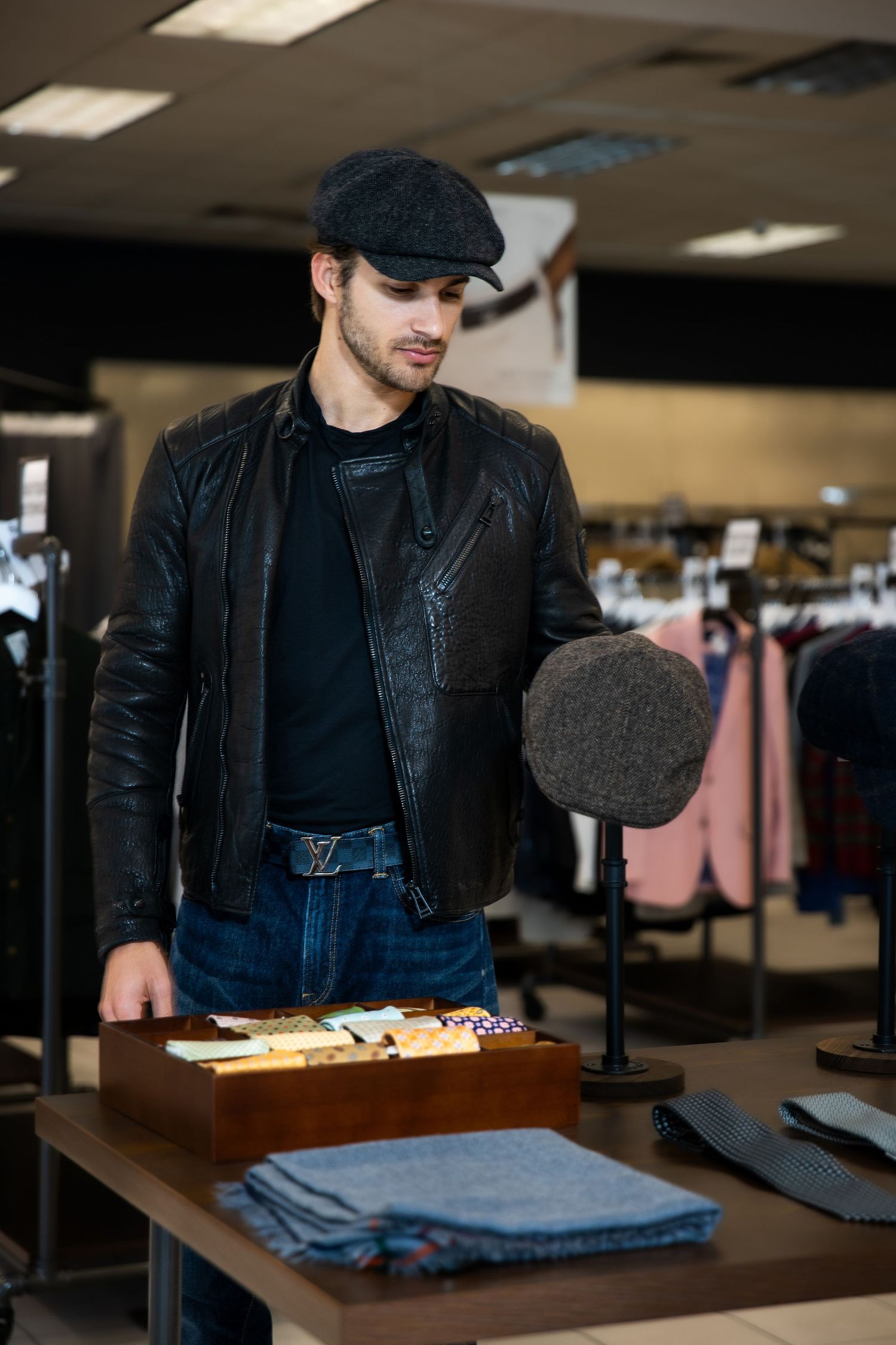 A series of retail clothing store photos showing folded denim jeans and merchandise displays on wooden tables.