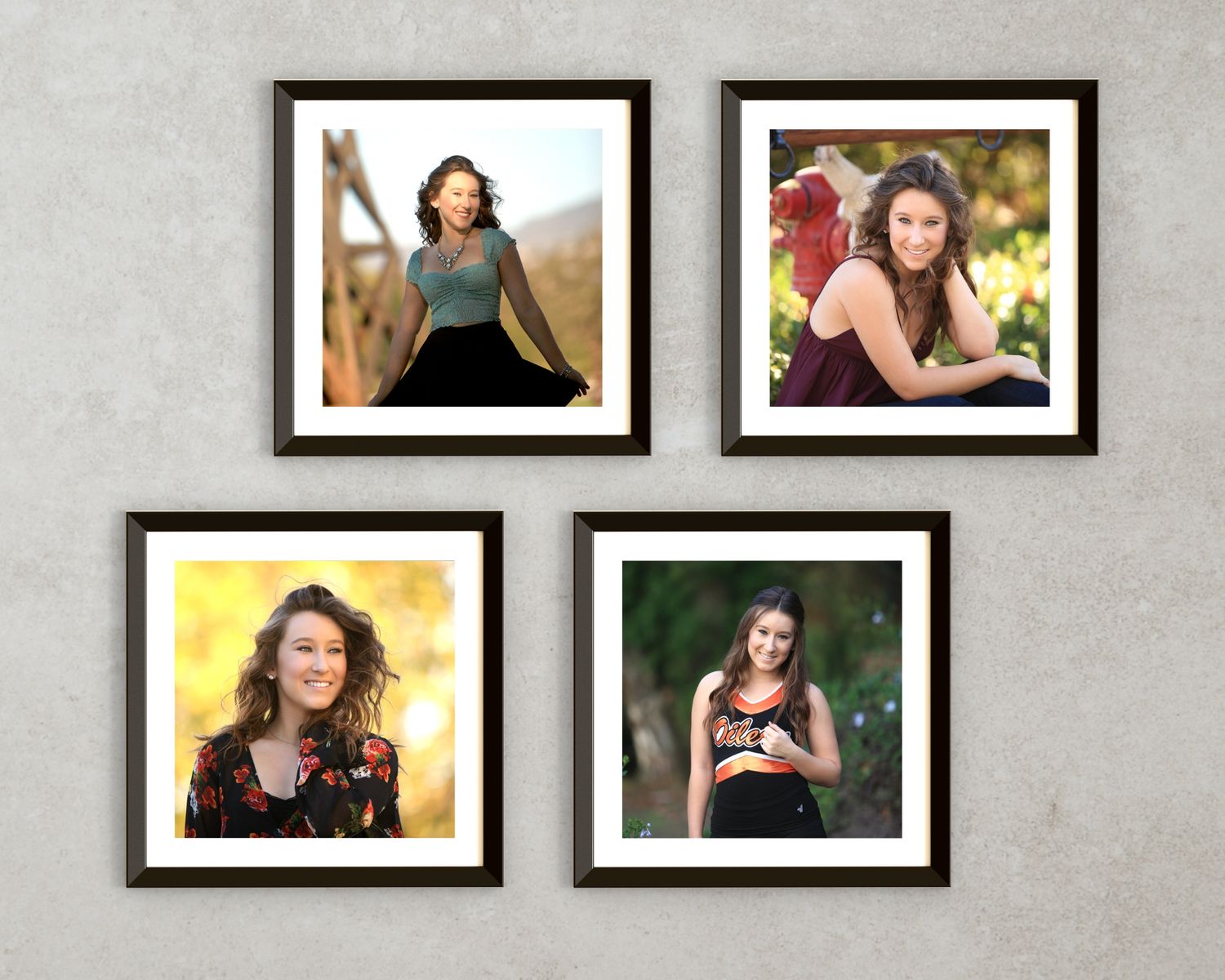Four framed portrait photographs arranged in a grid pattern against a light gray wall.
