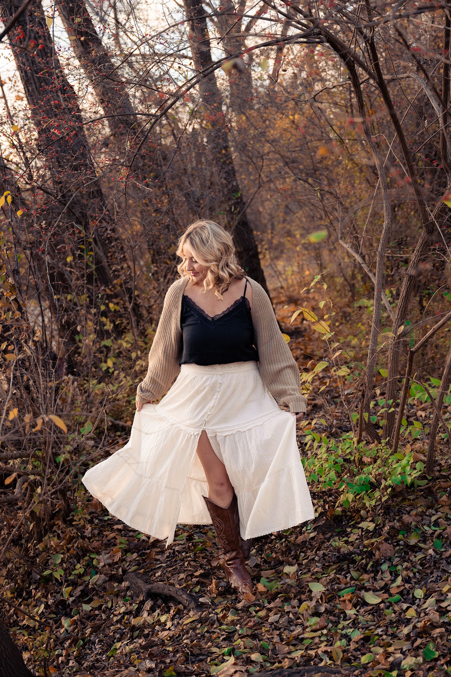 Artistic outdoor portrait series among fall foliage with flowing white dress.