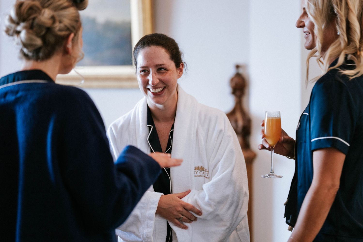 Wedding morning preparation scene with navy and white robes.