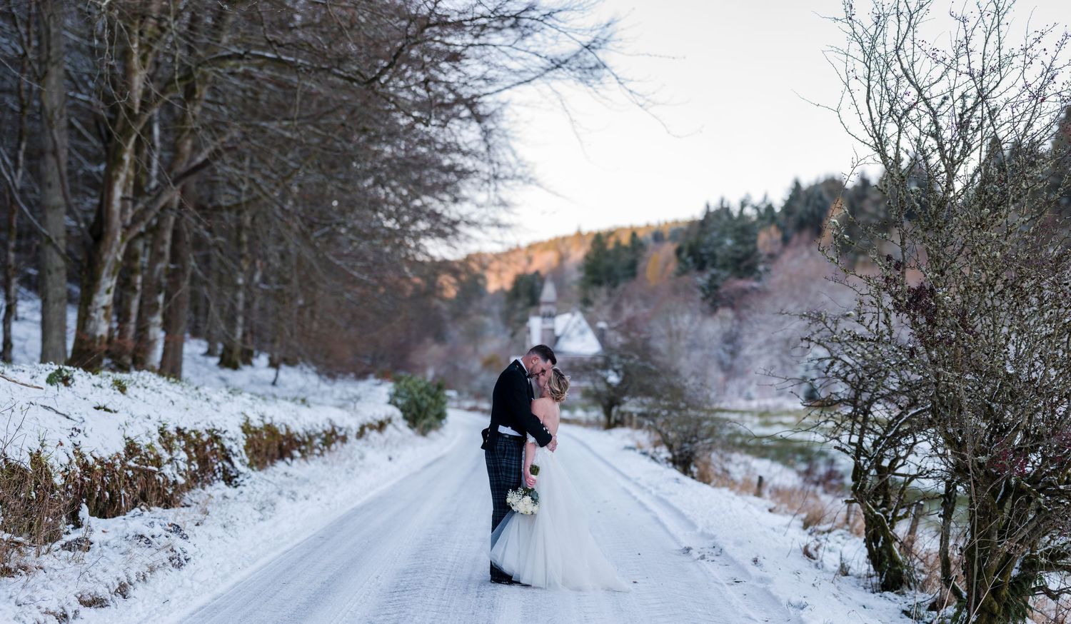 Aberdeen Wedding Photography. Snow covered winter forest path with bare trees lining the way.
